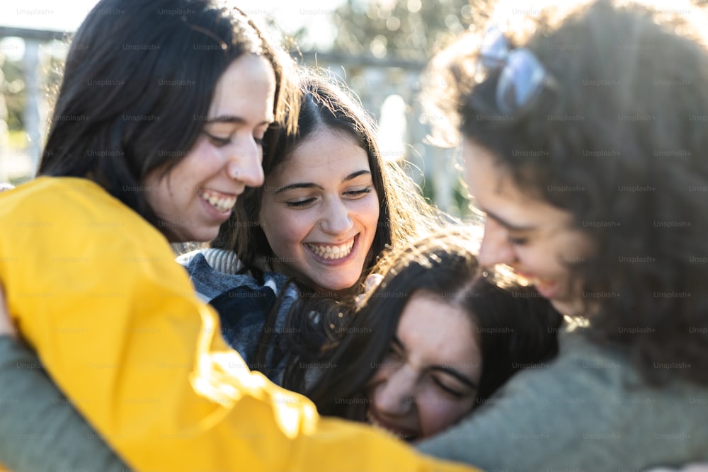 a group of young women hugging each other