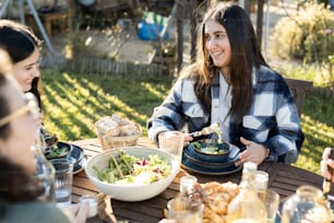 a group of people sitting around a table eating food