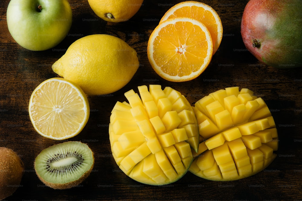 a wooden table topped with cut up fruit