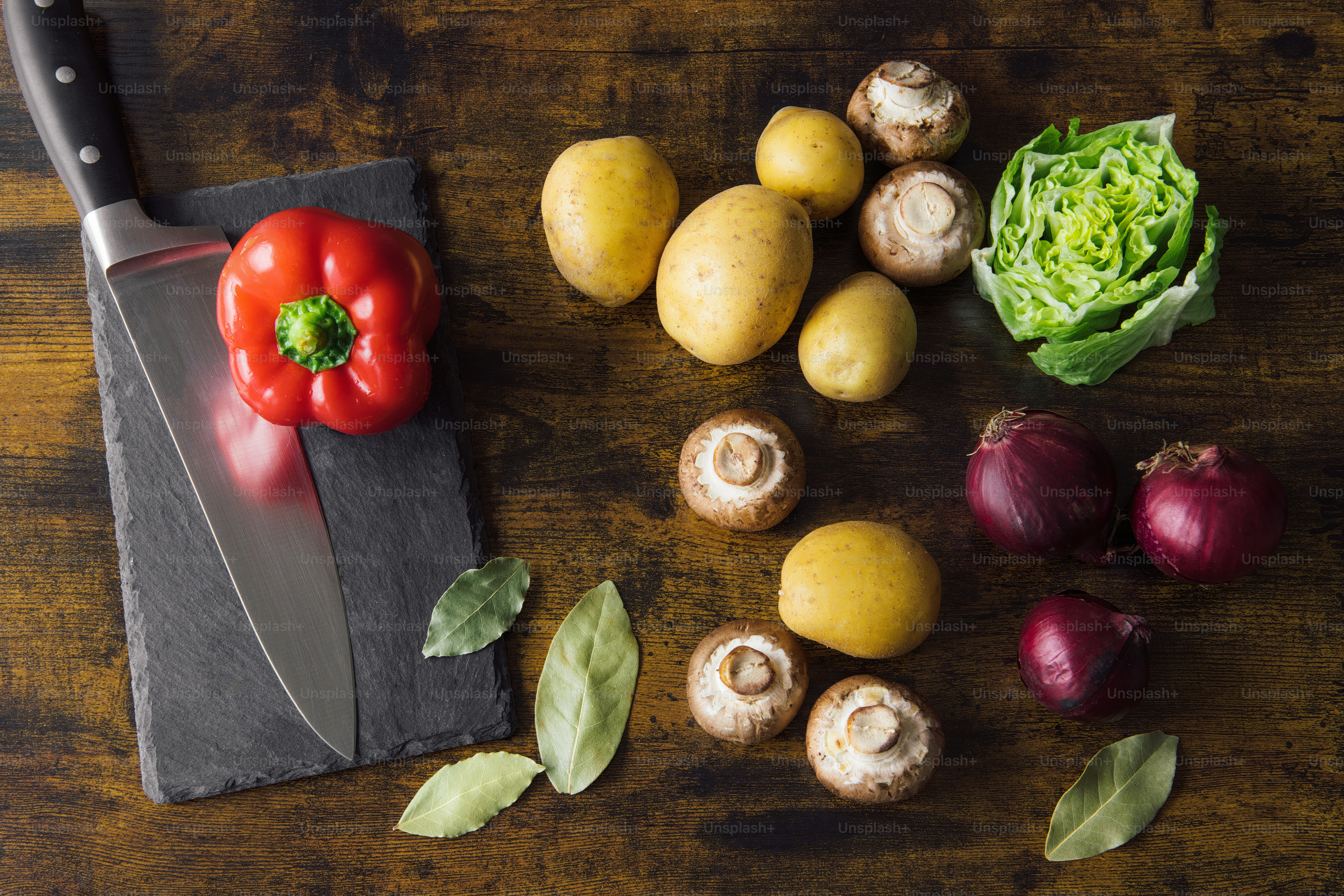 a cutting board with vegetables and a knife on it