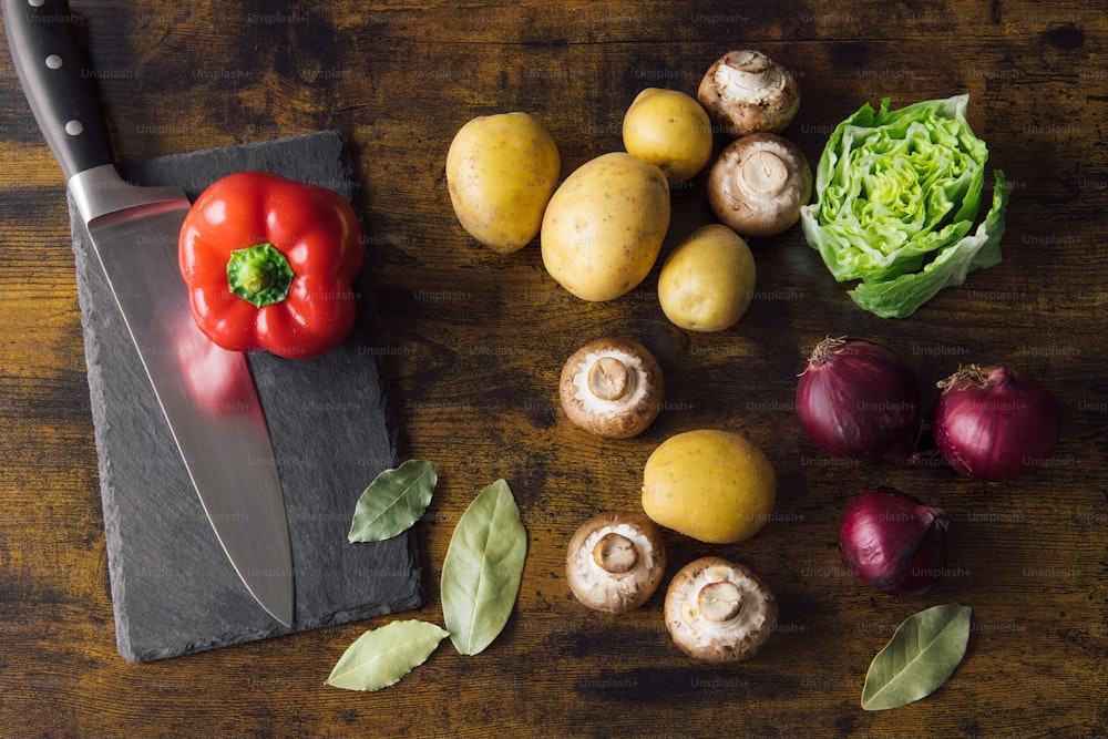 a cutting board with vegetables and a knife on it