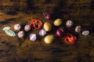 a wooden table topped with different types of vegetables