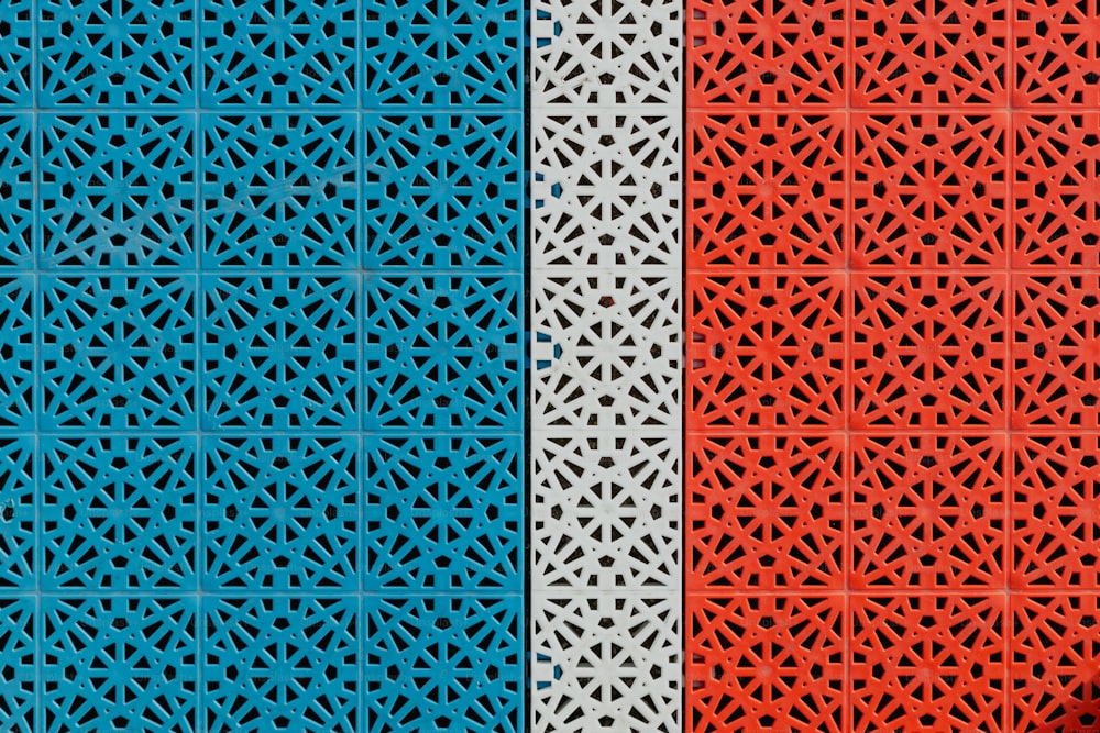 a red, white and blue wall with a pattern on it