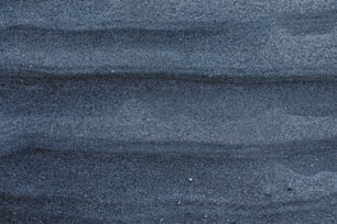 Eine Nahaufnahme von Sand und Wasser mit blauem Himmel im Hintergrund