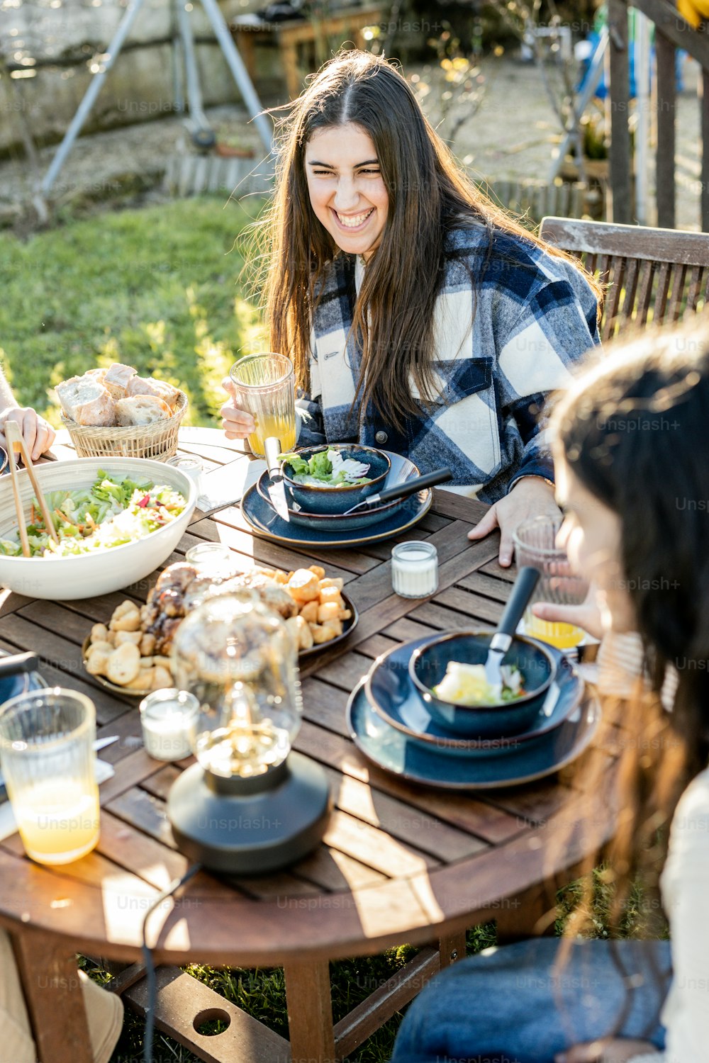 a group of people sitting around a wooden table