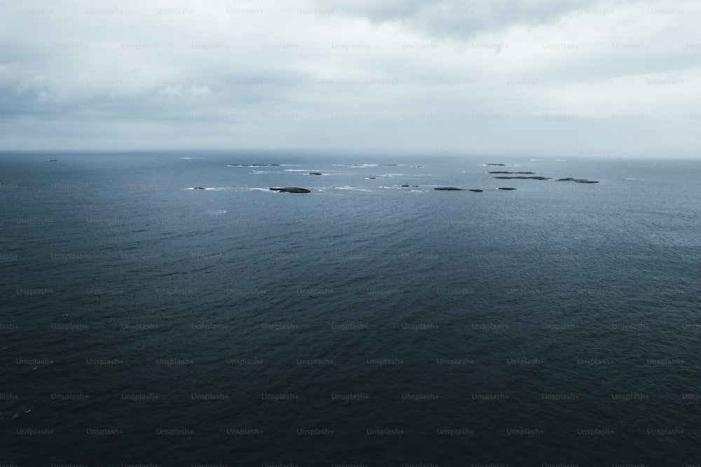 a group of rocks in the middle of a body of water