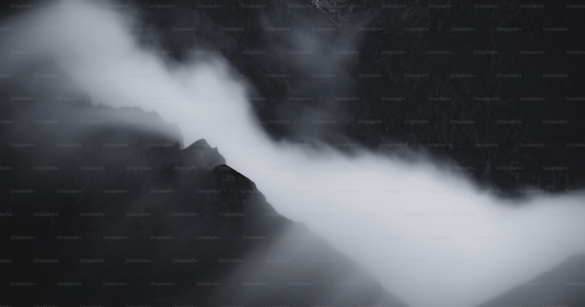 A black and white photo of mountains and clouds photo โ Nature Image on ...