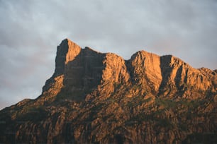 a very tall mountain with a sky in the background