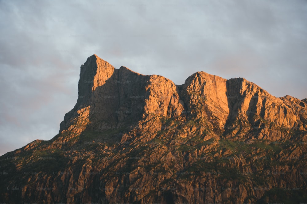 a very tall mountain with a sky in the background