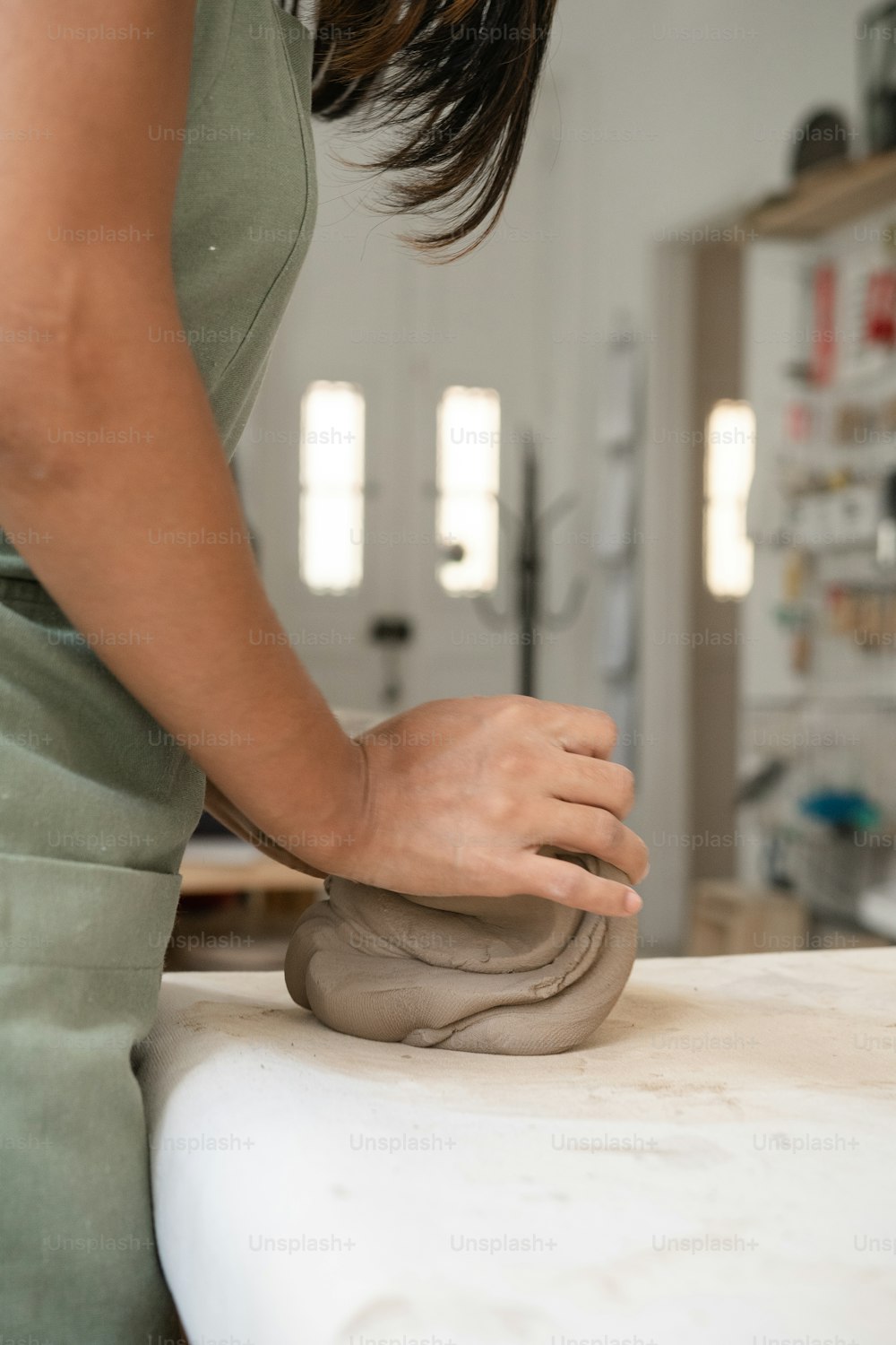 a woman is making a sculpture with clay
