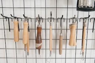 a bunch of kitchen utensils hanging on a wall
