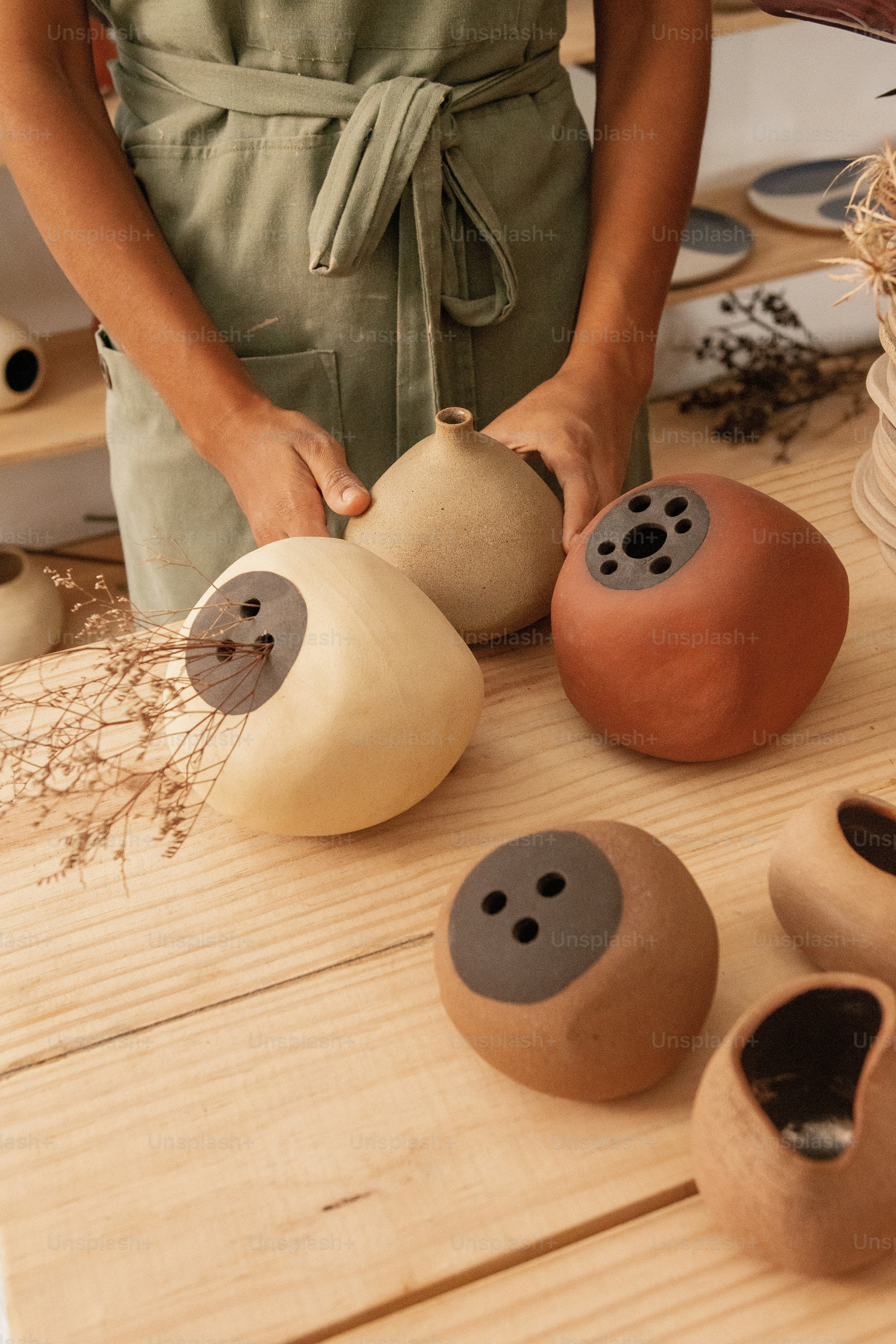 a person standing in front of some pottery