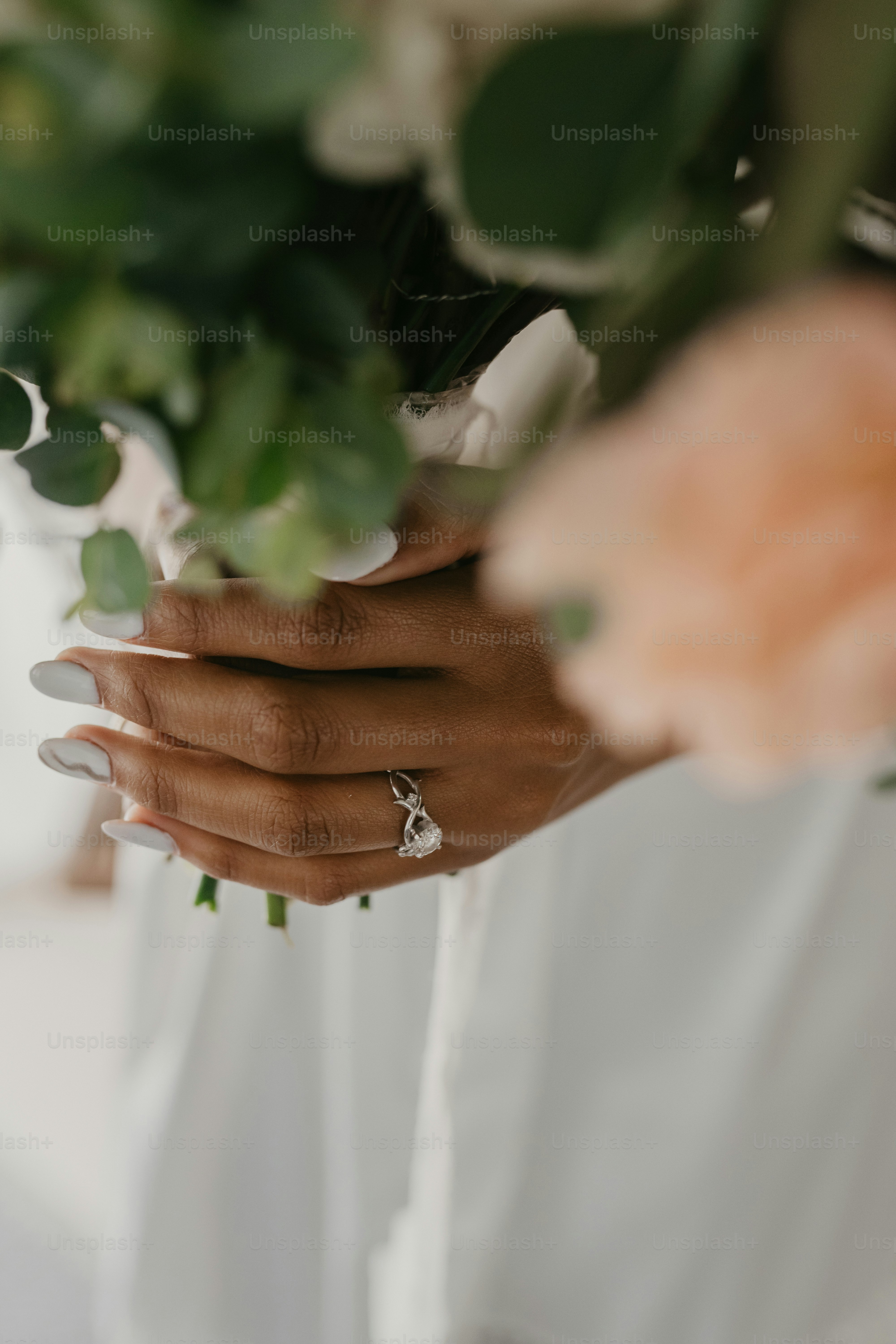 a close up of a person holding a bouquet of flowers