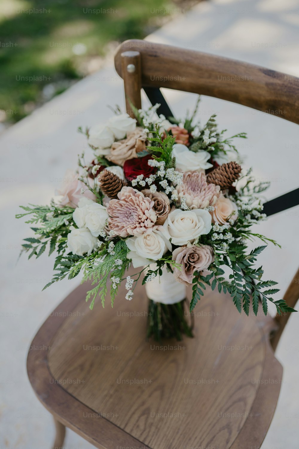 a bouquet of flowers sitting on top of a wooden chair