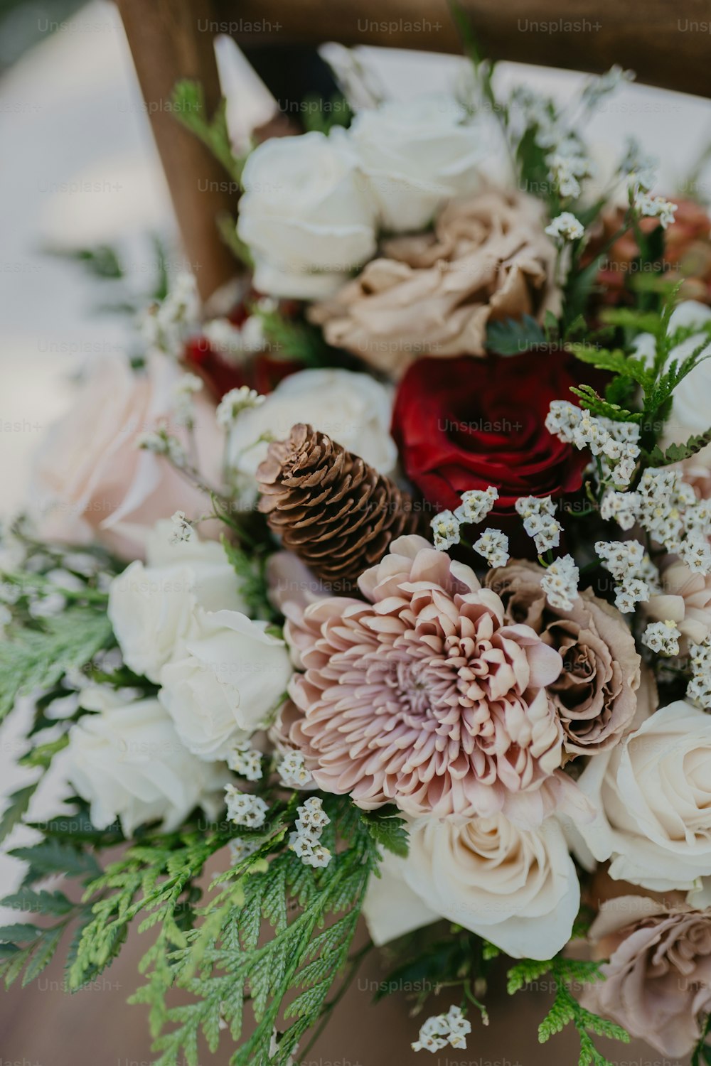 a bouquet of flowers sitting on top of a wooden chair