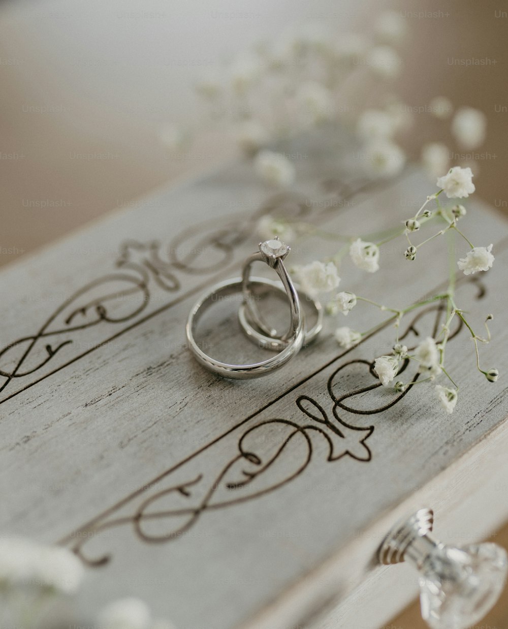 a couple of rings sitting on top of a wooden box