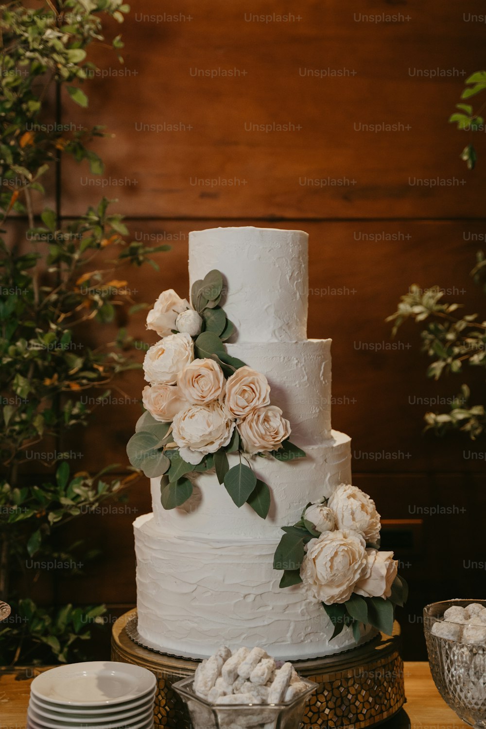 a white wedding cake with flowers on a table