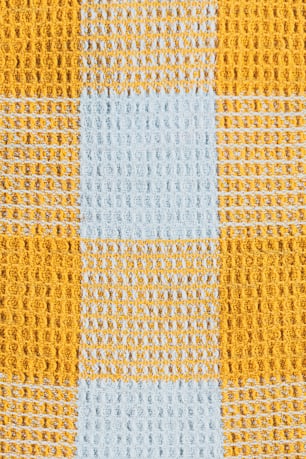 a close up of a yellow and blue checkered fabric