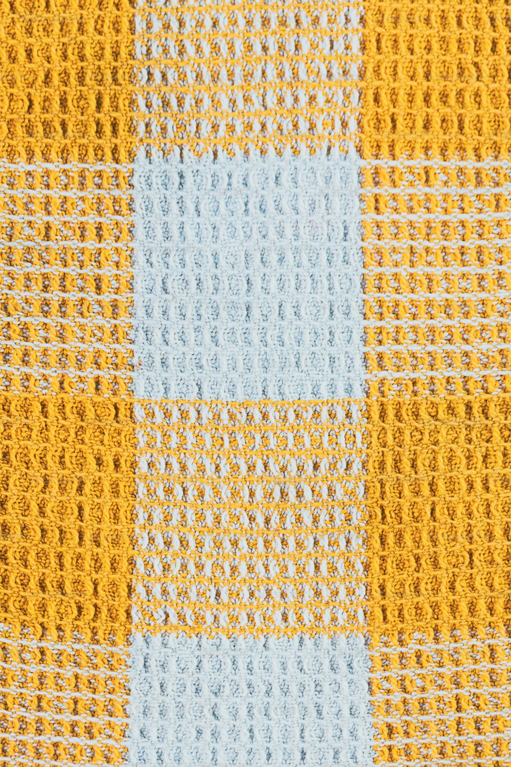 a close up of a yellow and blue checkered fabric