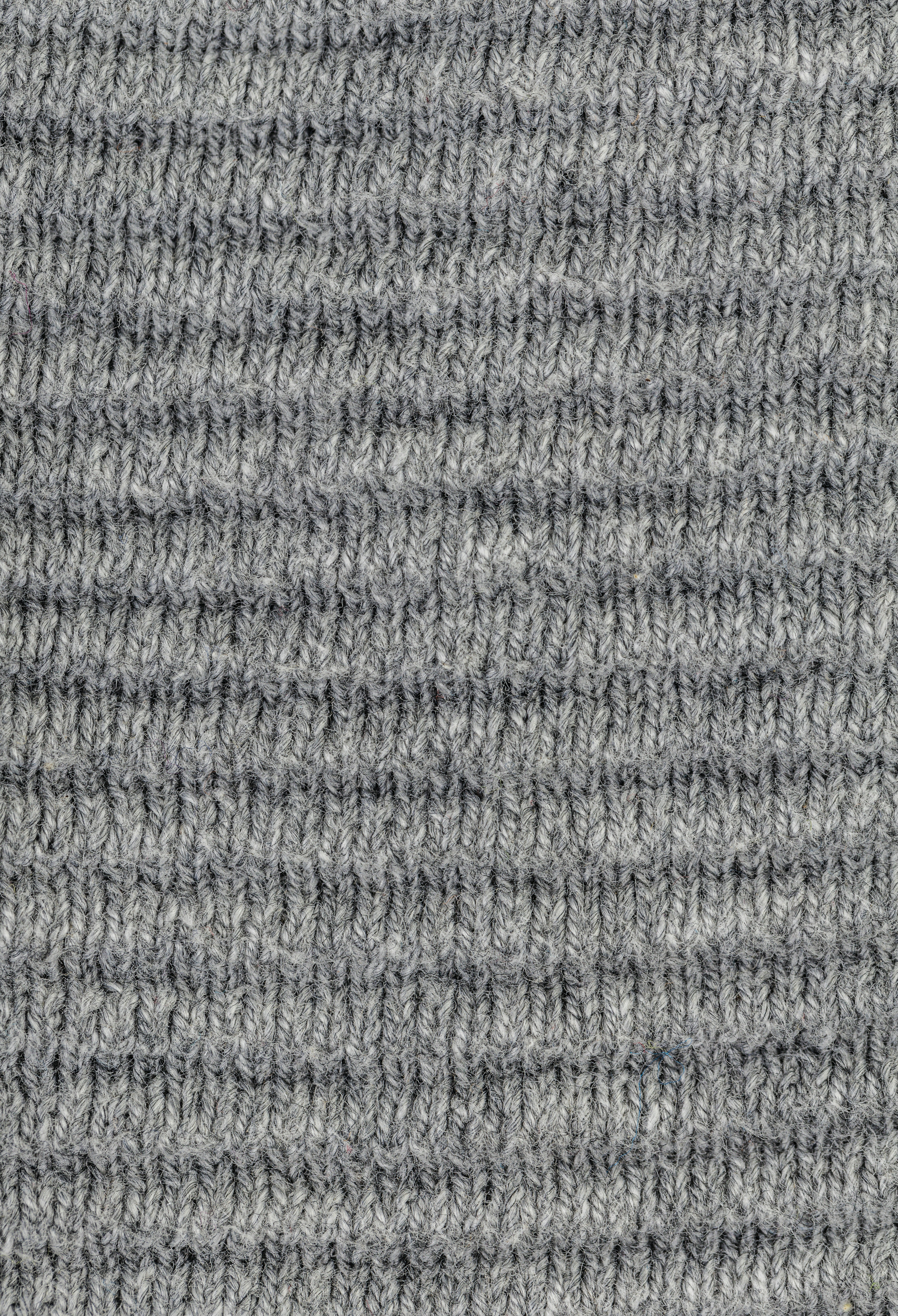 a close up of a gray knitted material