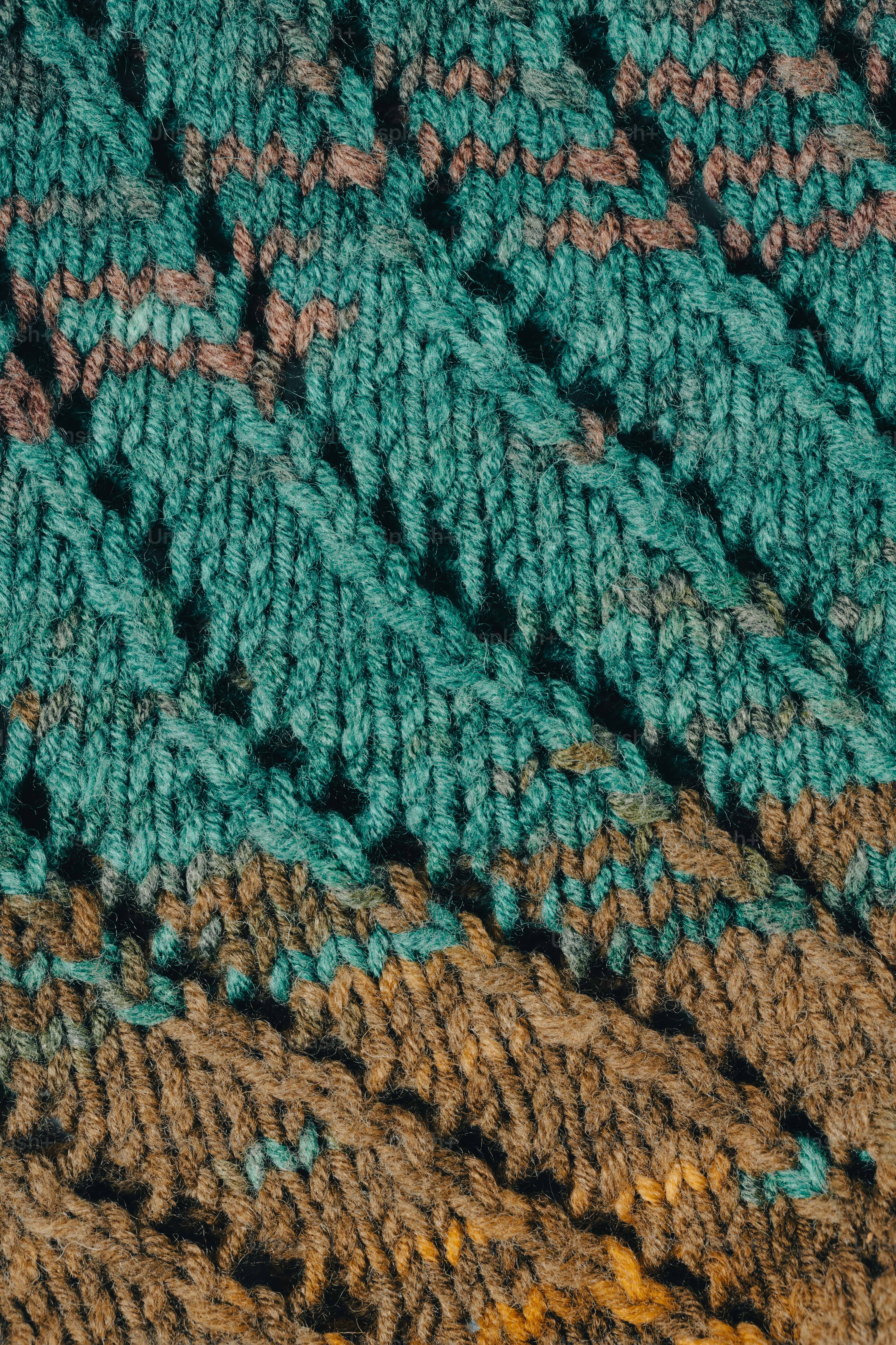 a close up of a crocheted blanket with a bird on it