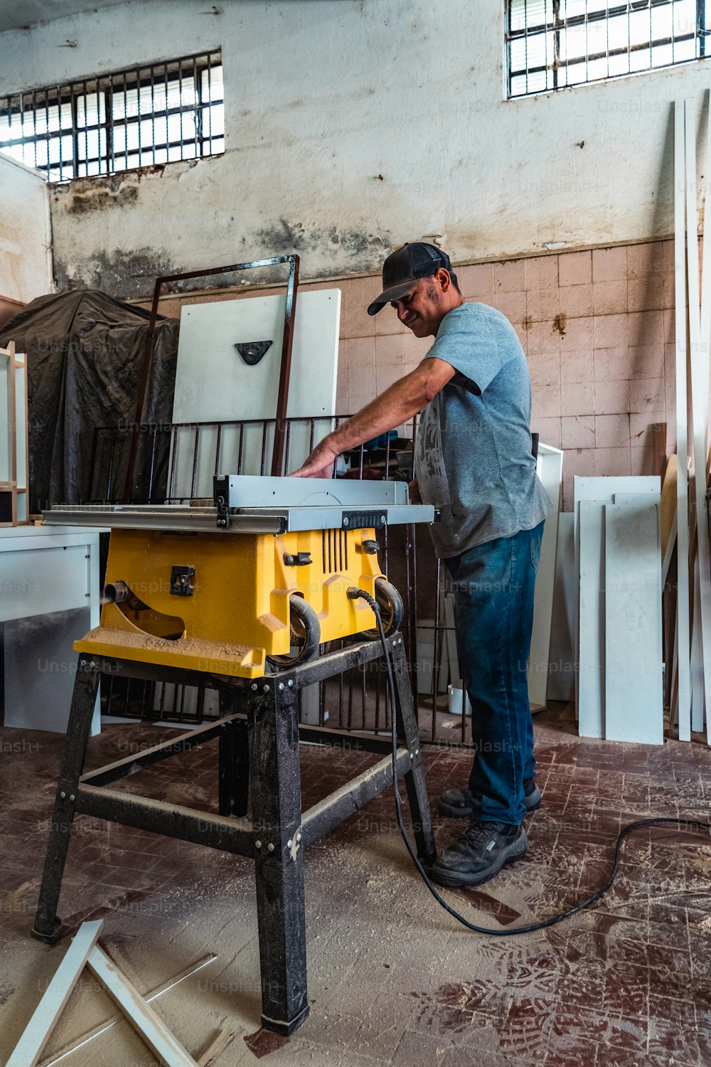 a man working on a table sawing a piece of wood