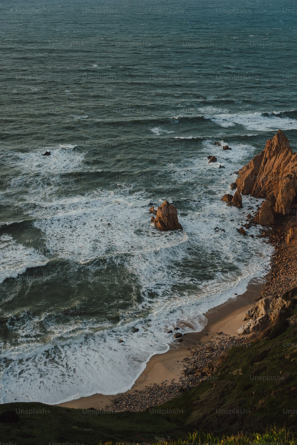 a view of the ocean from the top of a hill