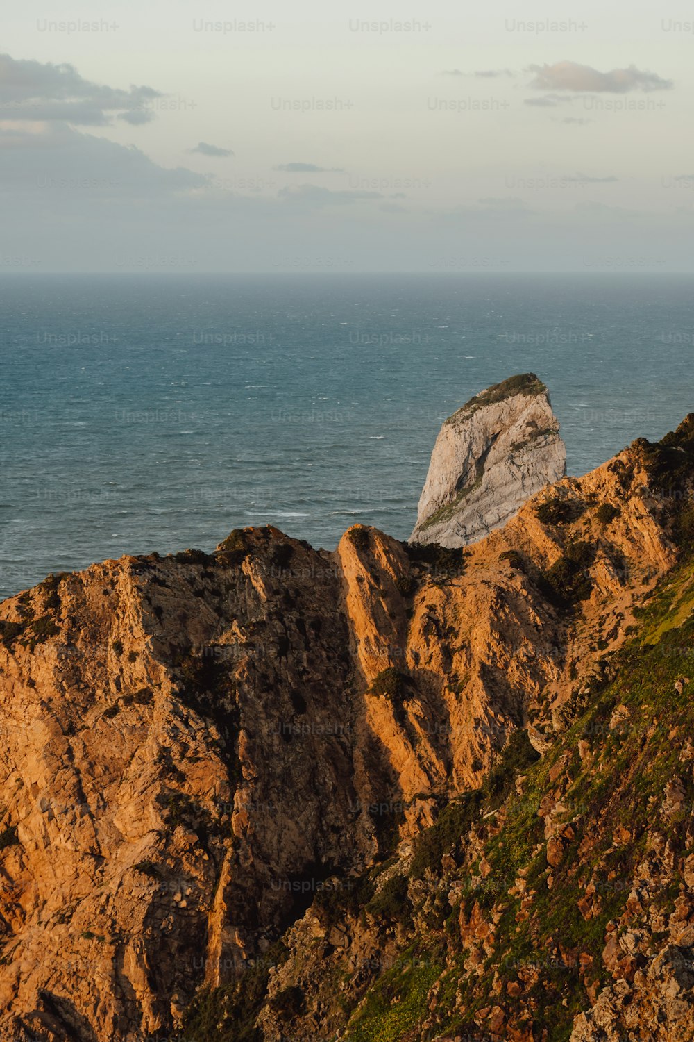 a large rock outcropping next to the ocean