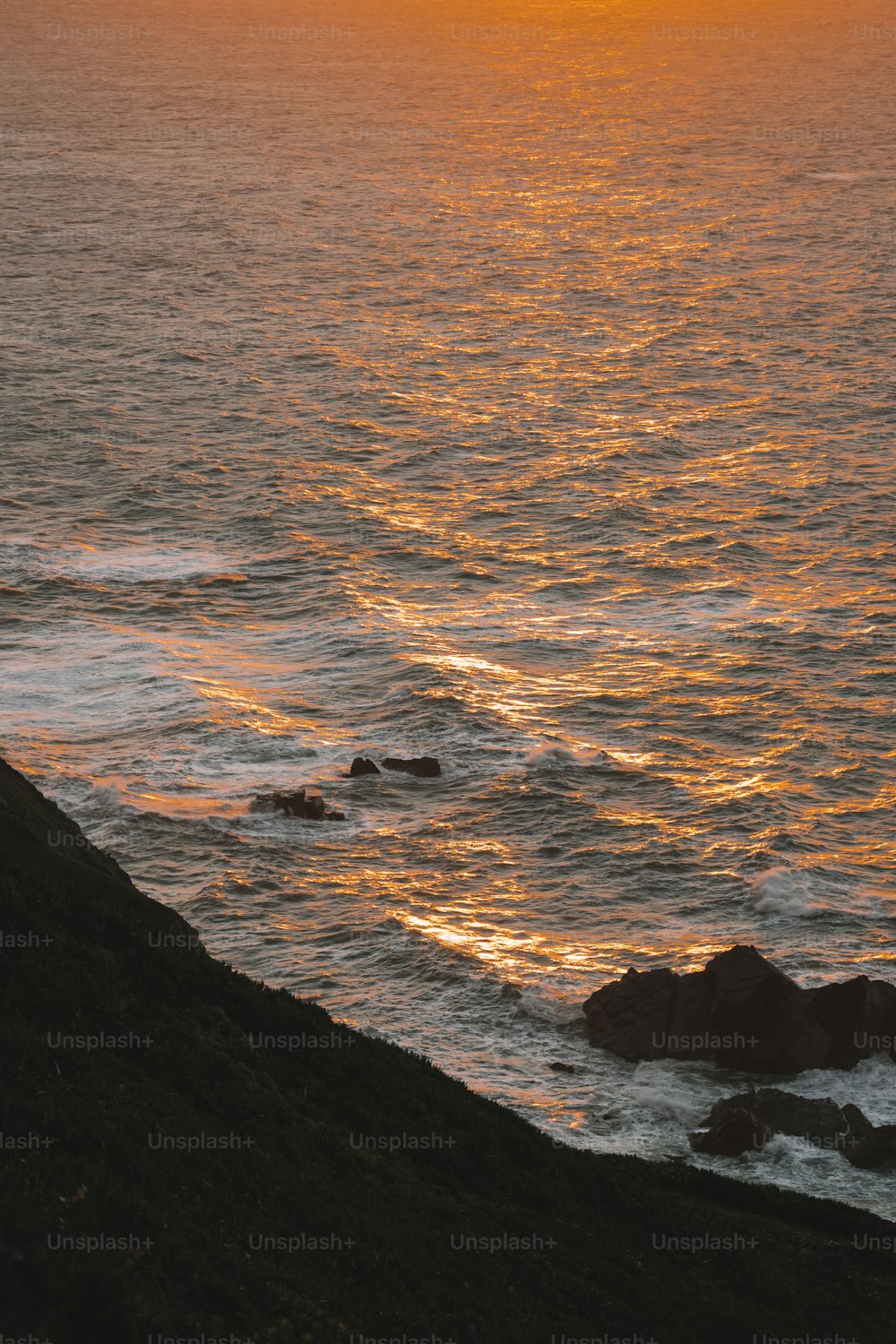 the sun is setting over the ocean with waves