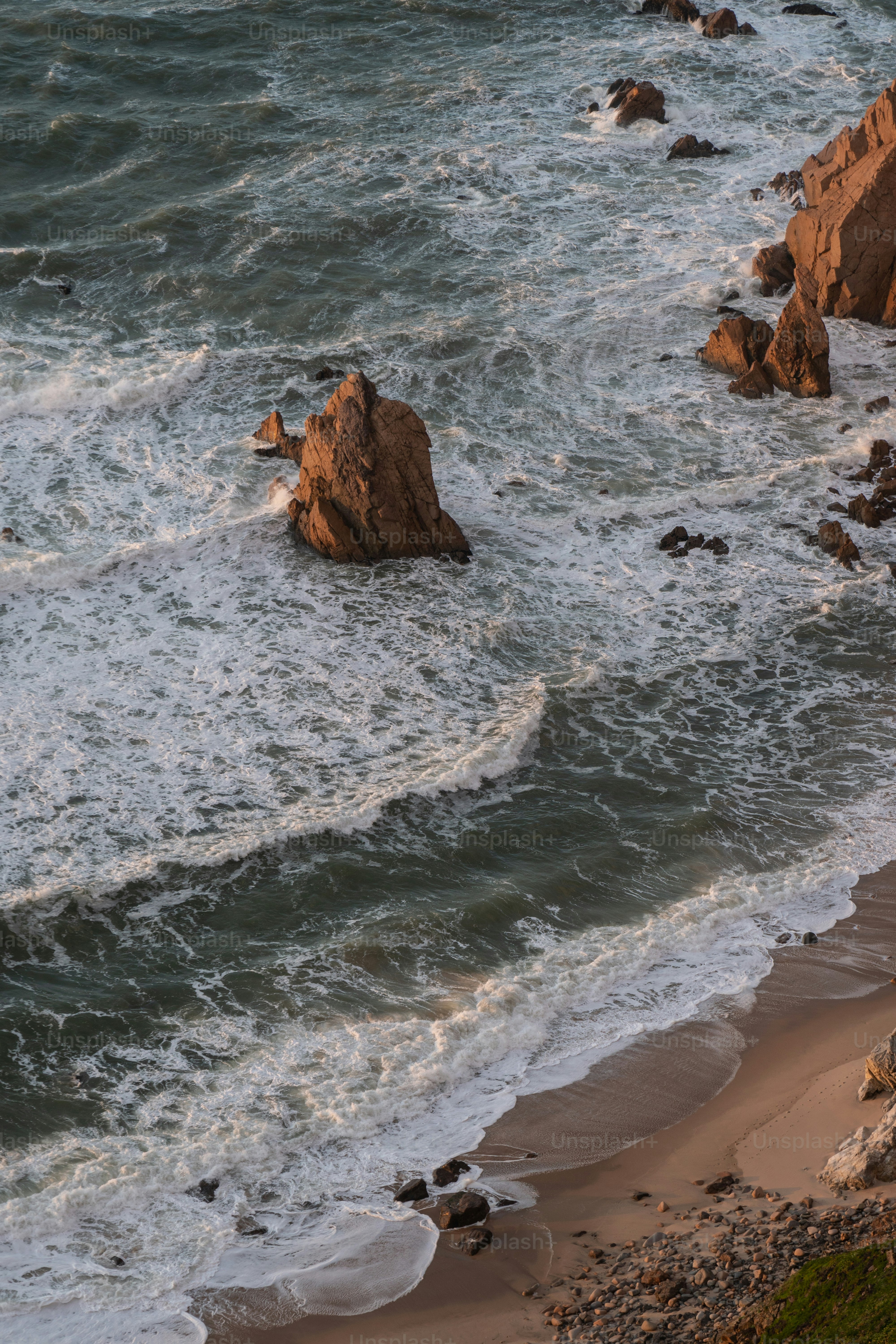A couple of large rocks sitting on top of a beach photo – Wallpapers ...