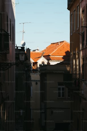 a view of a rooftop from a narrow alley way