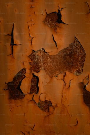 a rusted metal surface with cracks in it