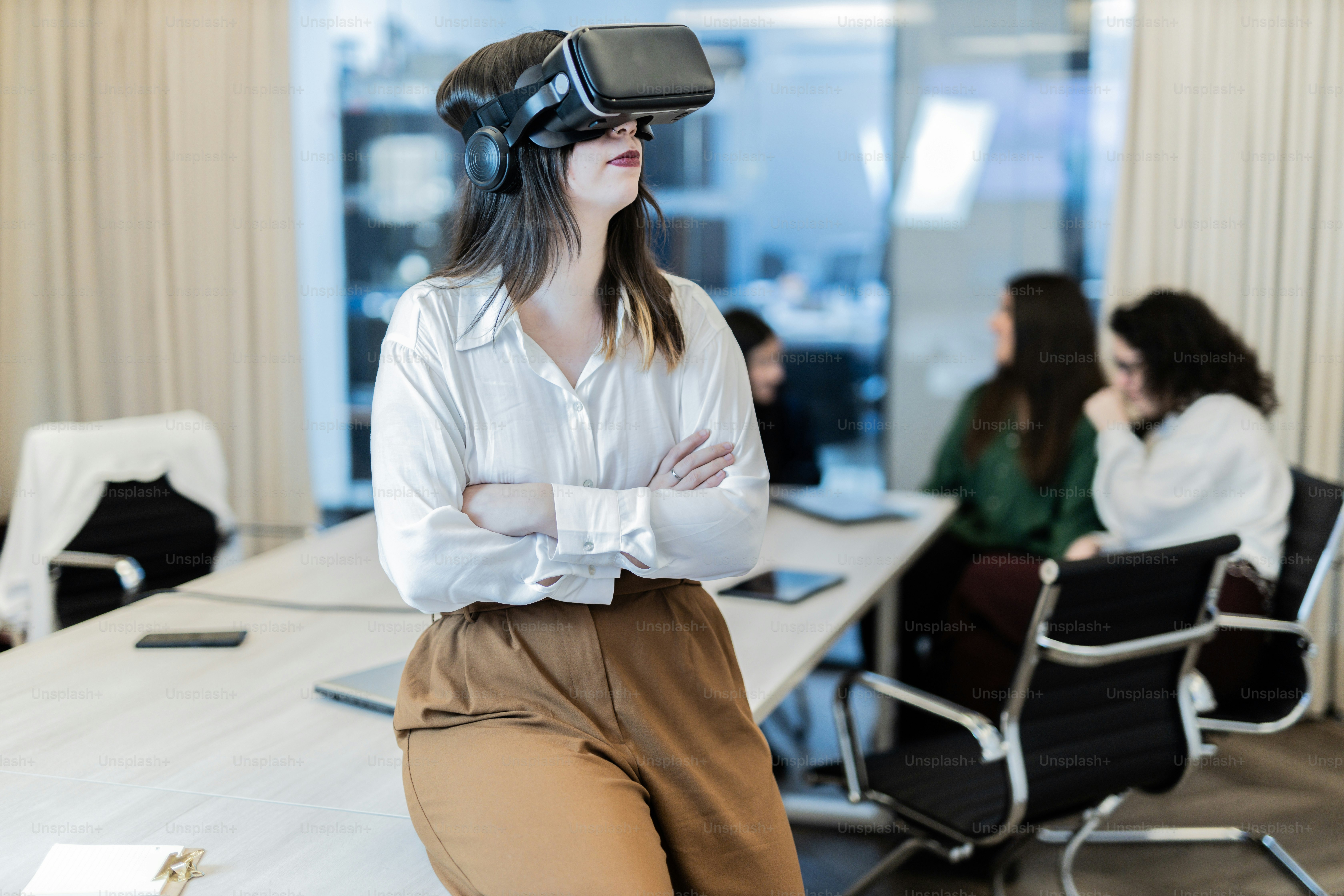 a woman wearing a virtual reality headset in a meeting room