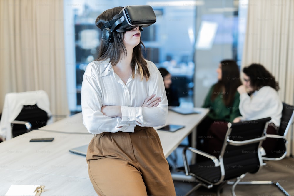 a woman wearing a virtual reality headset in a meeting room