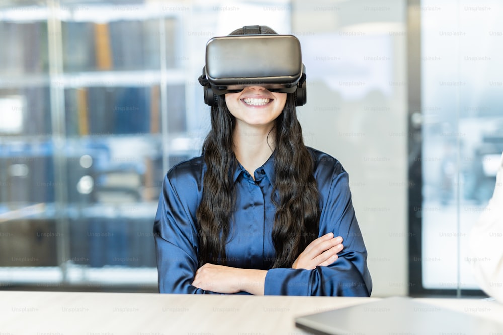 a woman in a blue shirt is wearing a virtual headset