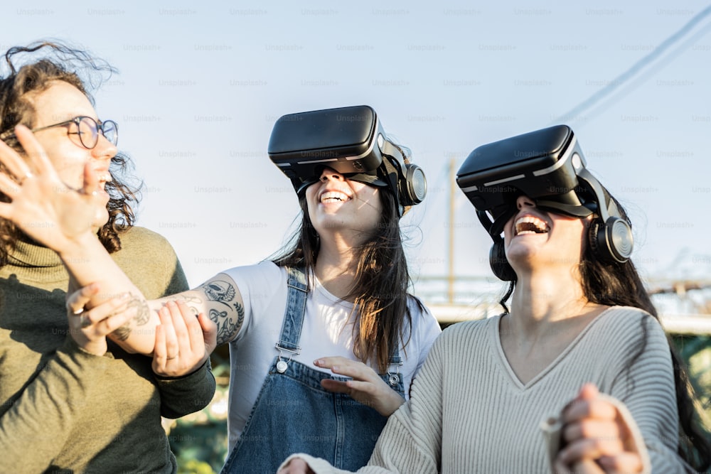 a group of women standing next to each other wearing virtual headsets