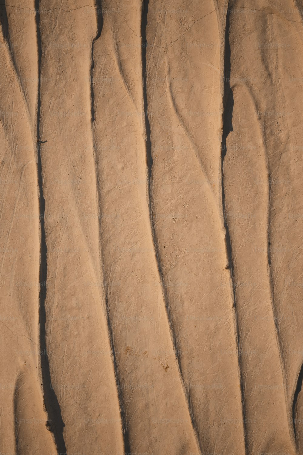 a close up of a sand dune with wavy lines