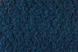 Un primer plano de la textura de una alfombra azul
