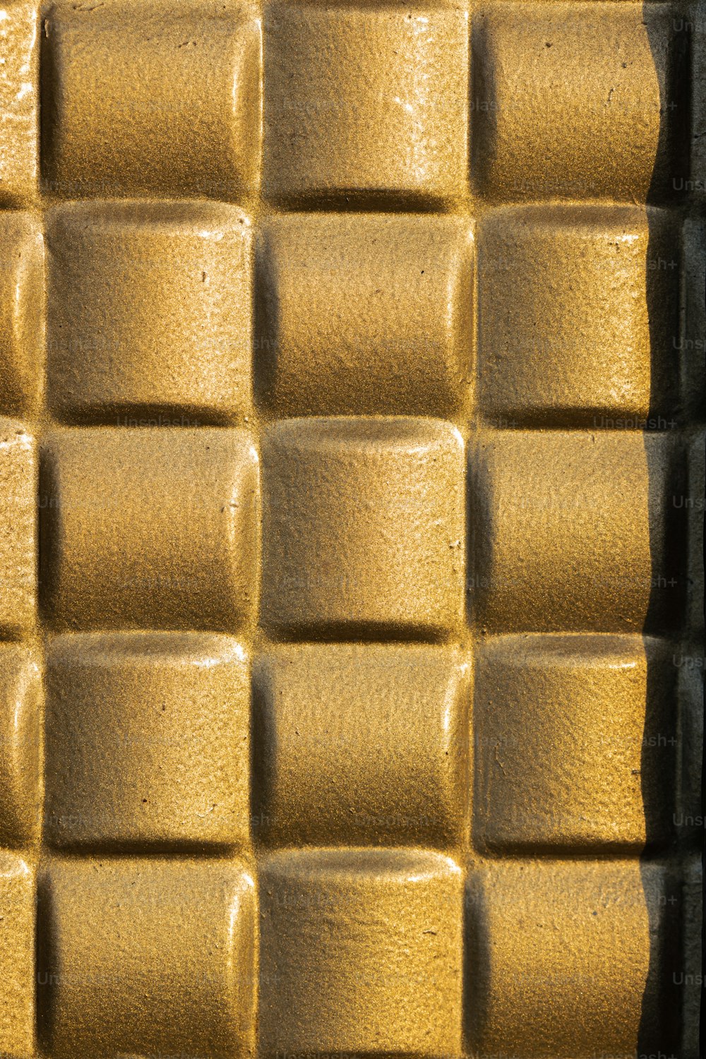 a close up of a wall made of yellow bricks