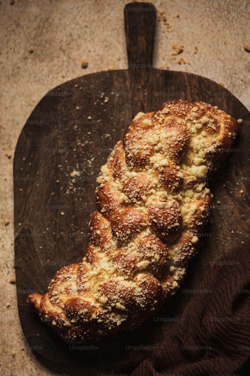 a piece of bread sitting on top of a wooden cutting board