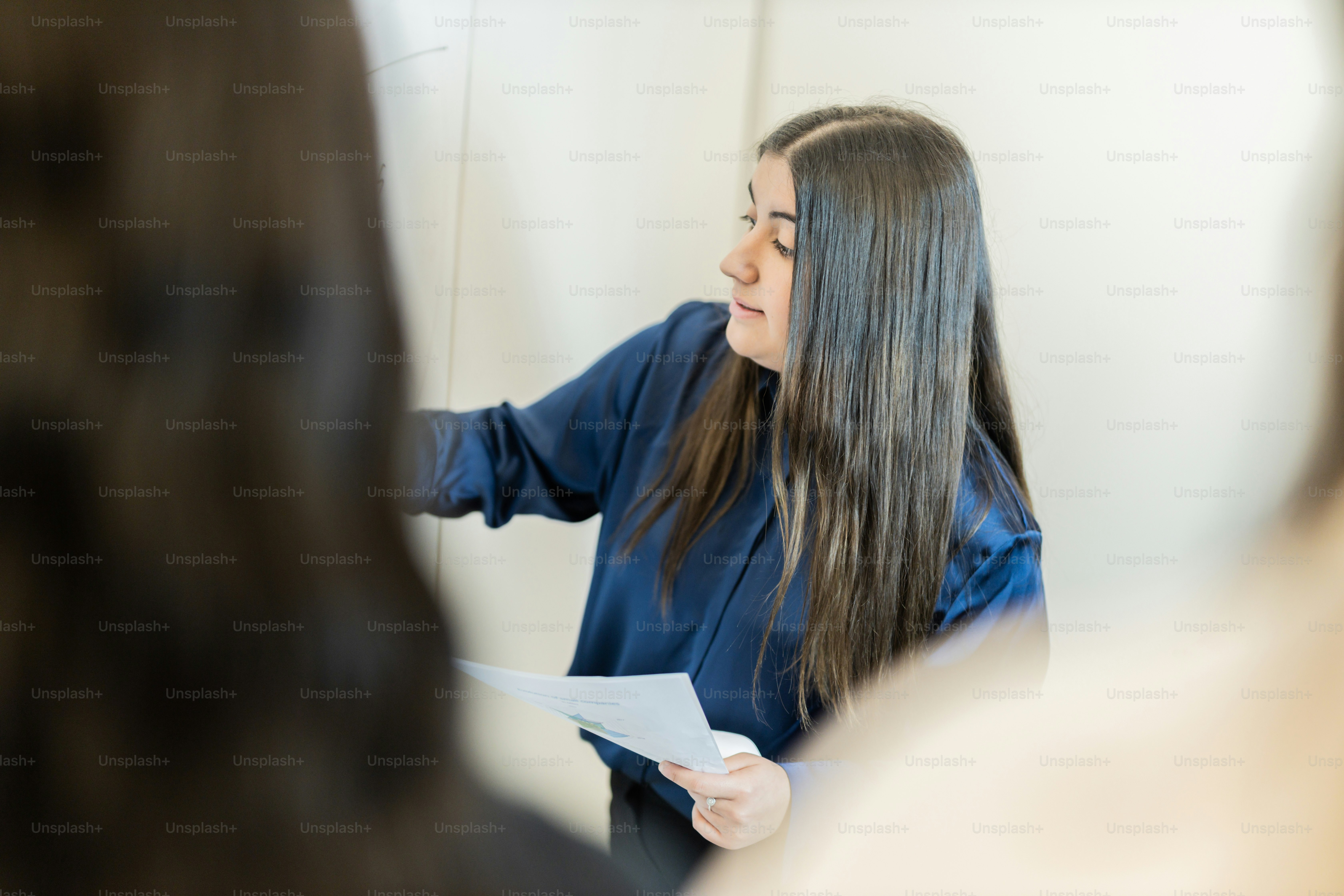 a woman holding a piece of paper in front of her face
