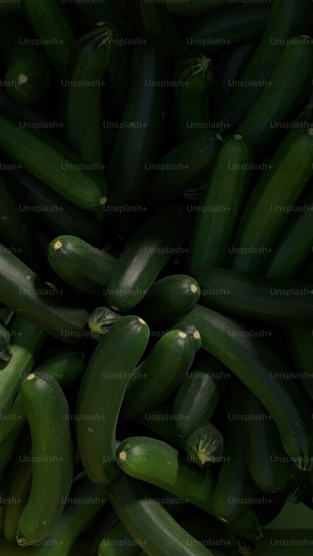 a pile of green cucumbers sitting next to each other