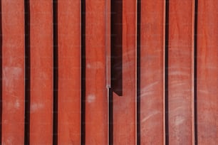 a close up of a red wall with a clock on it