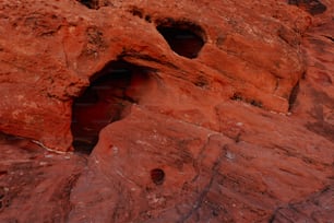 a rock formation with holes in the side of it