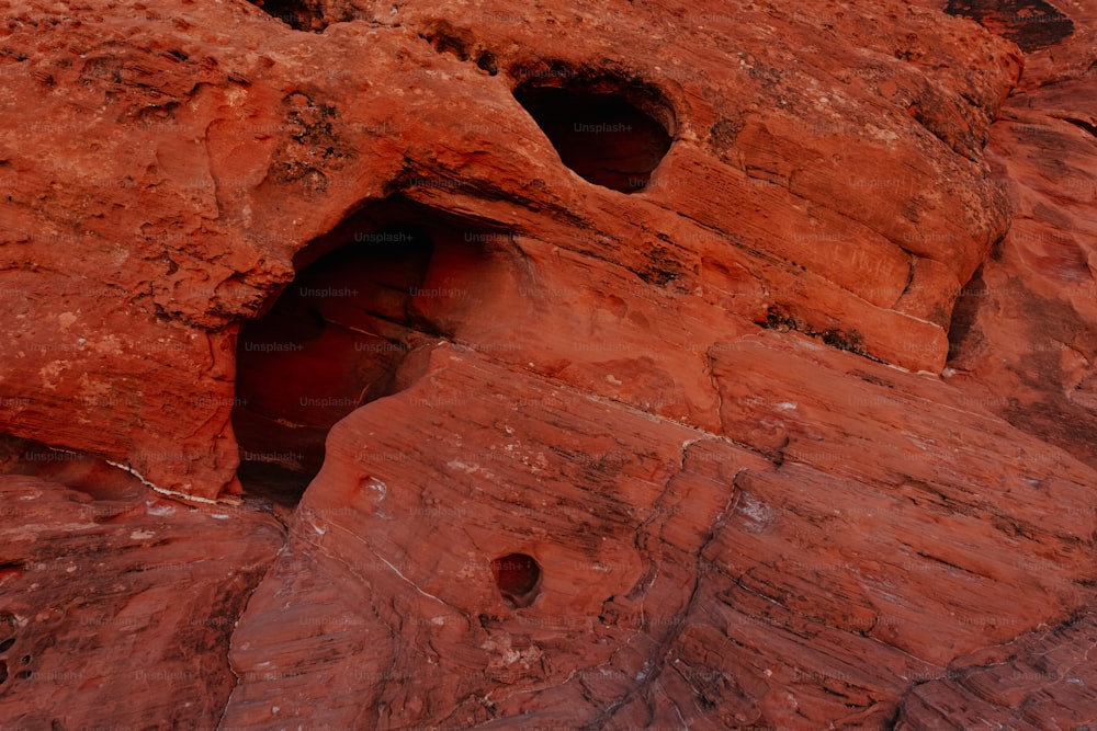 a rock formation with holes in the side of it