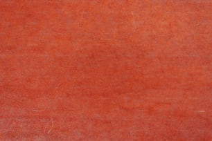 a red area rug with a white border