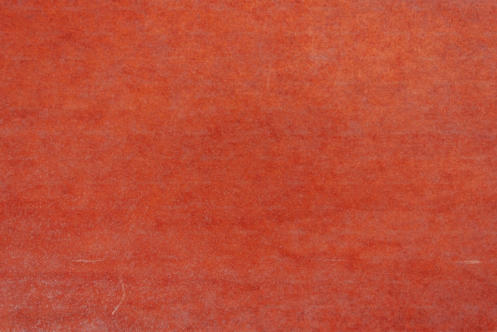 a red area rug with a white border