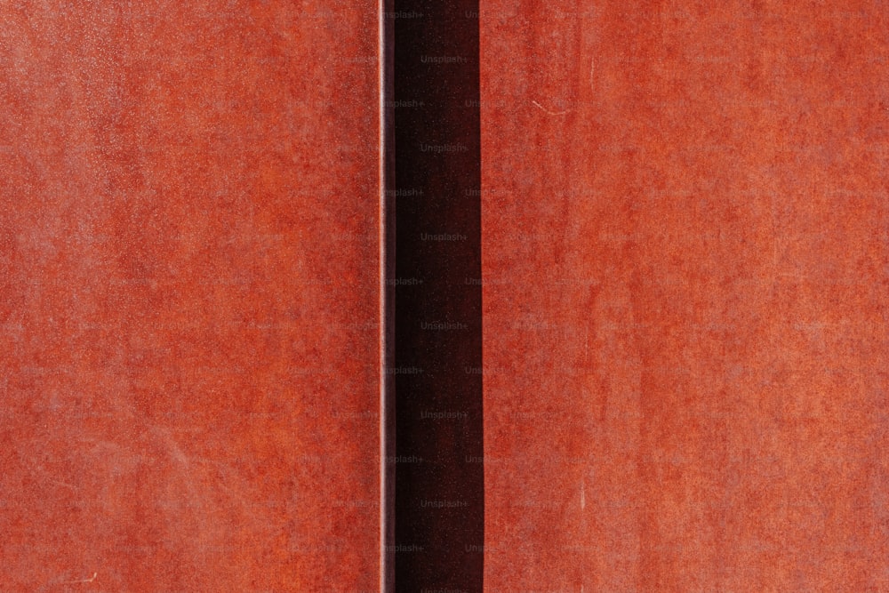 a close up of a wooden door with a black handle