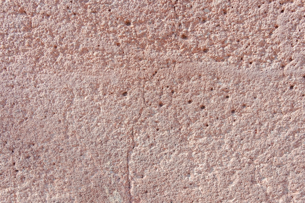 a close up of a wall with small holes in it