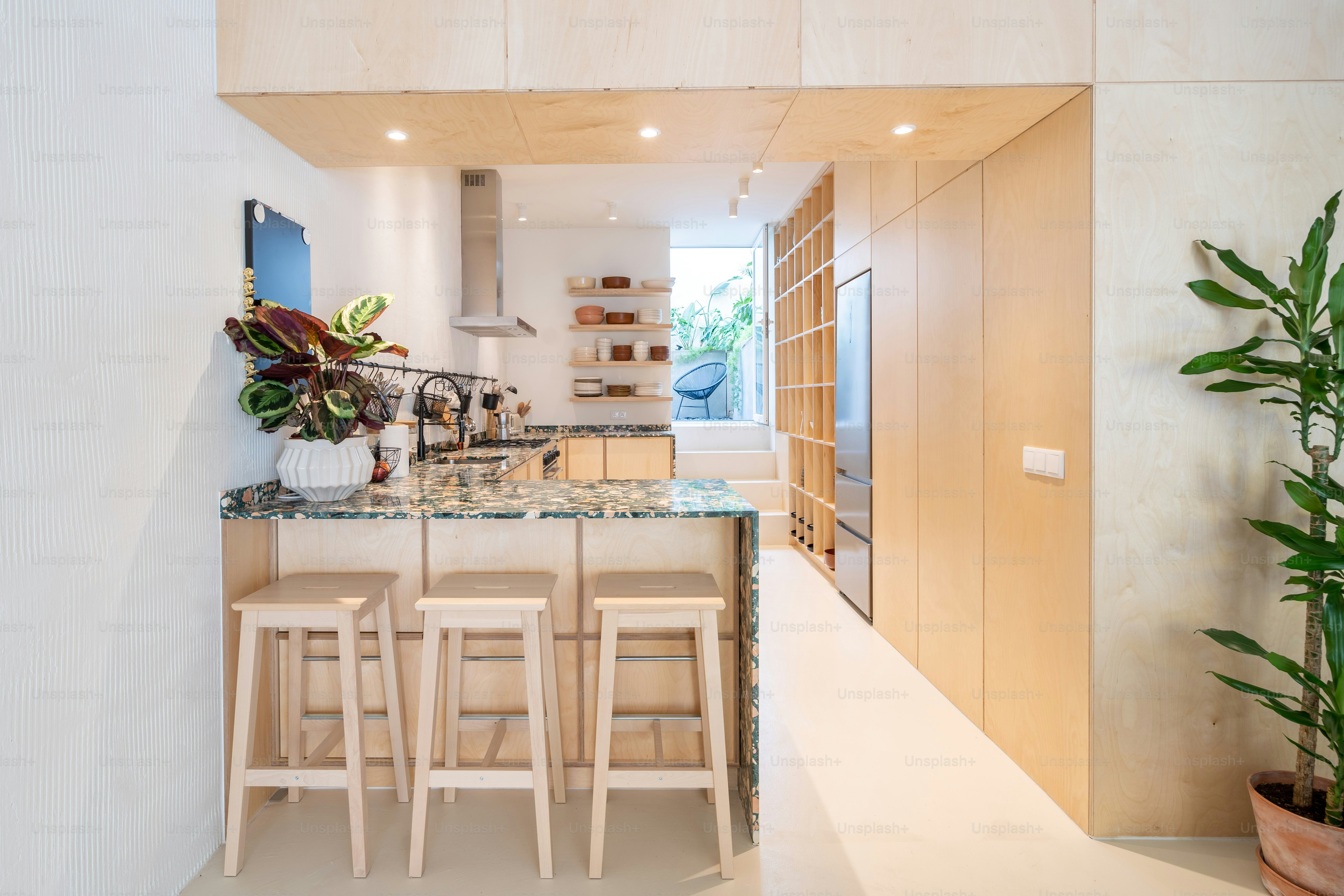 a kitchen with a marble counter top and wooden stools